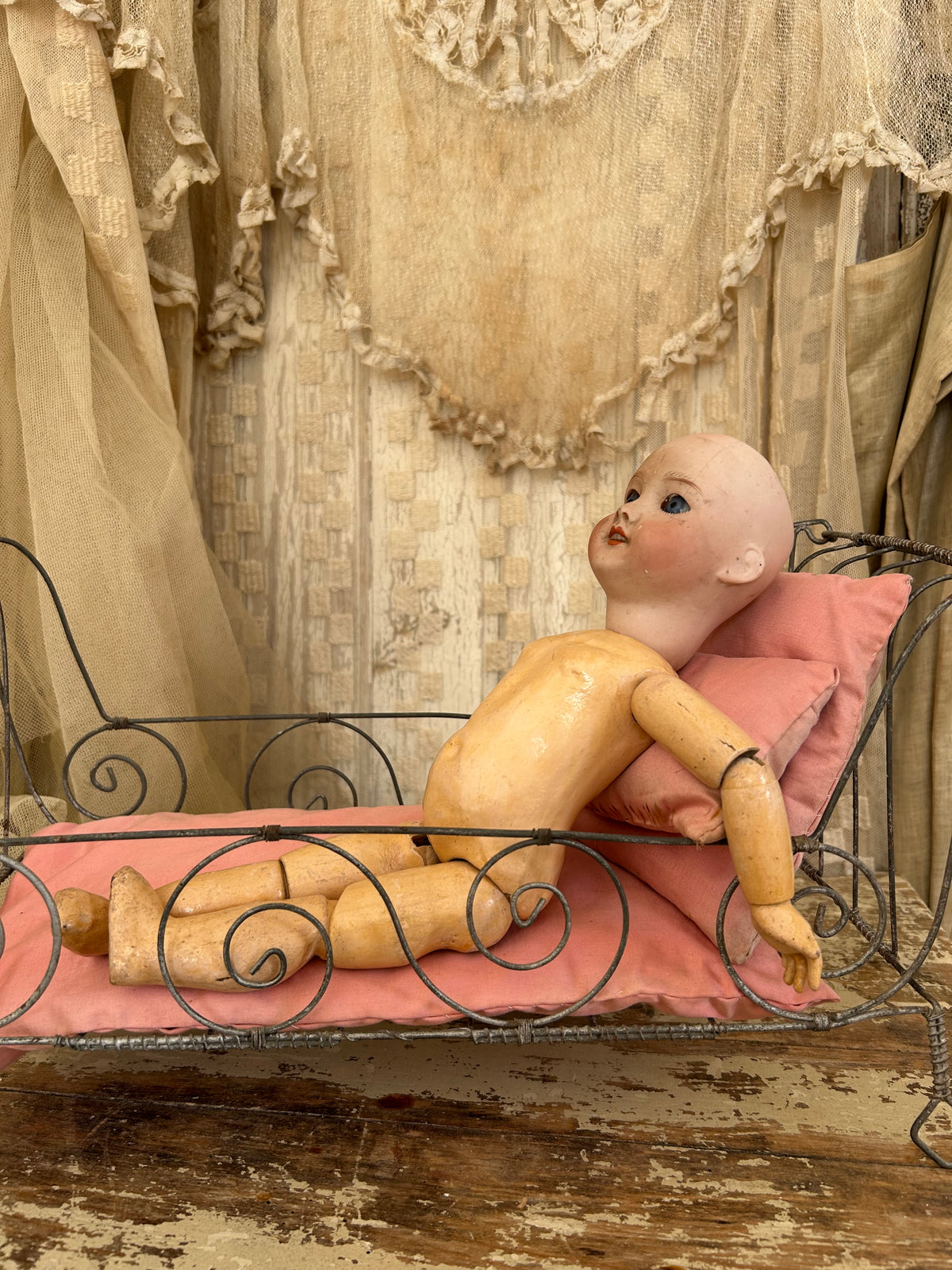 French antique doll bed with original mattress and pillows.