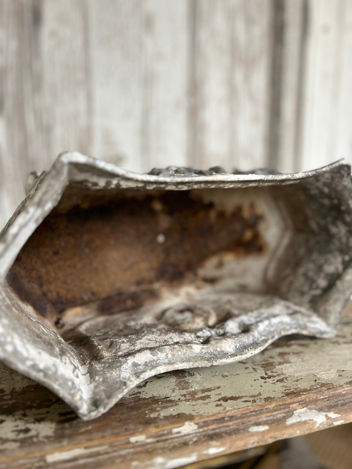Antique french jardiniere with embossed floral/scroll relief and scroll feet.