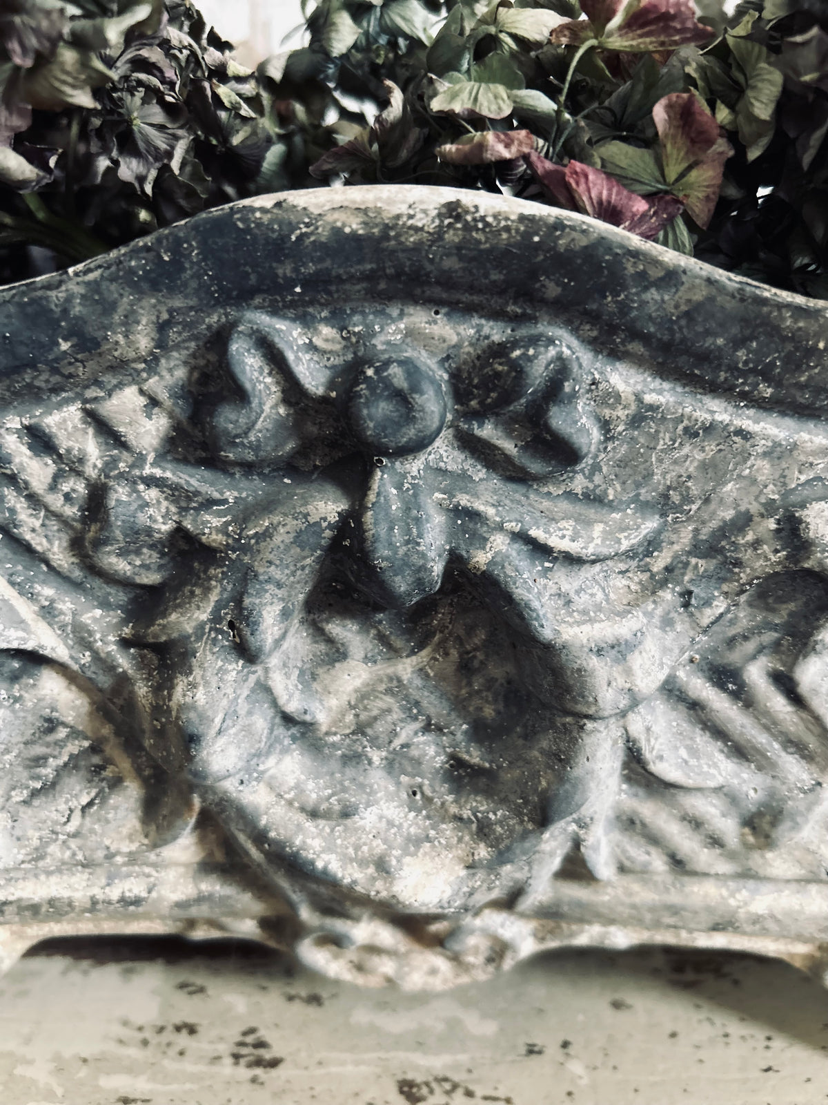Antique french jardiniere with embossed floral/scroll relief and scroll feet.