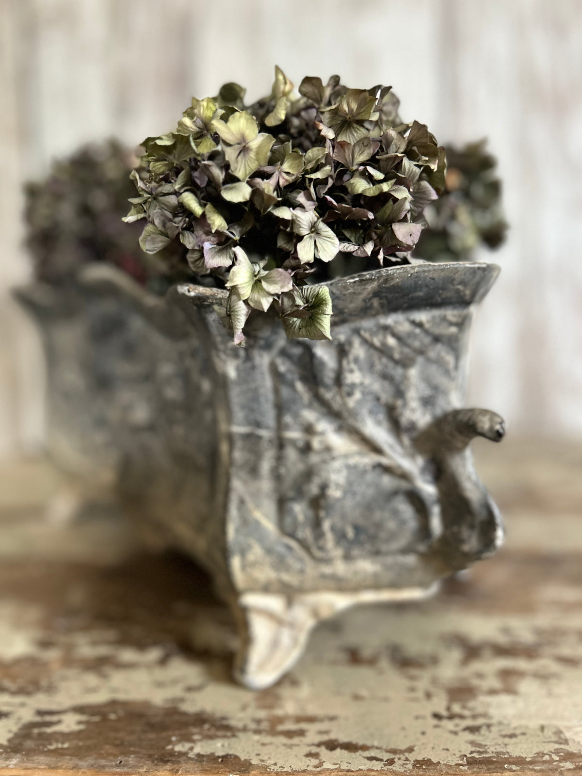 Antique french jardiniere with embossed floral/scroll relief and scroll feet.